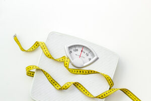 scale and measure tape relating to weight loss